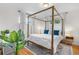 Bright bedroom with four-poster bed, hardwood floors, and modern decor at 2075 Oakland St, Aurora, CO 80010