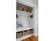 Convenient mud room with built-in bench, storage baskets, and coat hooks at 2075 Oakland St, Aurora, CO 80010