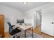 Well-lit office area with hardwood floors, a modern desk, and easy access to other rooms in the home at 2075 Oakland St, Aurora, CO 80010