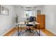 Bright office space featuring a light wood desk, stylish rug, and a large window with natural light at 2075 Oakland St, Aurora, CO 80010