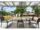 View of the patio area featuring a metal overhang, a black and white rug, and comfortable seating at 2075 Oakland St, Aurora, CO 80010