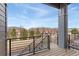 Balcony with metal railings offers a view of the neighborhood and a seating area, extending the living space outdoors at 9099 Prairie Sky Ln, Lone Tree, CO 80124