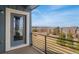 Scenic view from the private balcony overlooking mature landscaping and city neighborhood at 9099 Prairie Sky Ln, Lone Tree, CO 80124