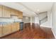 Open basement living area featuring wood floors and a wet bar with granite countertops at 9099 Prairie Sky Ln, Lone Tree, CO 80124