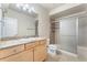 Bright bathroom featuring granite countertops, a frosted glass shower, and tile flooring at 9099 Prairie Sky Ln, Lone Tree, CO 80124