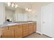 Bathroom featuring double vanity, granite countertops, ample storage and modern lighting at 9099 Prairie Sky Ln, Lone Tree, CO 80124