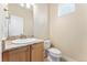 Bathroom features granite countertops, wood cabinets, and a tile floor at 9099 Prairie Sky Ln, Lone Tree, CO 80124