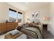 Bedroom with hardwood floors, a large window, and warm, inviting decor at 9099 Prairie Sky Ln, Lone Tree, CO 80124