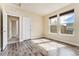 Bright bedroom with hardwood floors, large windows, and neutral colored walls at 9099 Prairie Sky Ln, Lone Tree, CO 80124