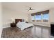 Bedroom features hardwood flooring, large windows, and neutral colored walls at 9099 Prairie Sky Ln, Lone Tree, CO 80124