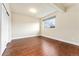 Bedroom with neutral color palette, wood floors, and sliding door closet at 9099 Prairie Sky Ln, Lone Tree, CO 80124