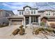 Charming two-story home featuring a well-manicured front yard and attached garage, showcasing great curb appeal at 9099 Prairie Sky Ln, Lone Tree, CO 80124