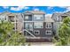 Rear exterior view of the home featuring a walkout basement and dual balconies at 9099 Prairie Sky Ln, Lone Tree, CO 80124