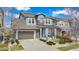 Inviting two-story home featuring a well-manicured lawn, gray painted exterior, and a convenient two-car garage at 9099 Prairie Sky Ln, Lone Tree, CO 80124