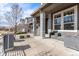 Inviting front porch with a seating area, steel railings and architectural columns, adding a cozy, modern touch at 9099 Prairie Sky Ln, Lone Tree, CO 80124