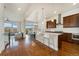 Spacious kitchen with an island featuring barstool seating, opening to the dining and living areas for easy socializing at 9099 Prairie Sky Ln, Lone Tree, CO 80124