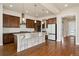 Open-concept kitchen with granite countertops, modern pendant lighting, and stainless steel appliances at 9099 Prairie Sky Ln, Lone Tree, CO 80124