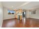 Open-concept living area featuring wood floors and a wet bar with granite countertops at 9099 Prairie Sky Ln, Lone Tree, CO 80124