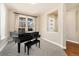 Well-lit piano room with a beautiful piano and large windows showcasing sheer curtains at 9099 Prairie Sky Ln, Lone Tree, CO 80124