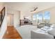 Bright living room with a modern fireplace, large windows, and a plush sofa provides a comfortable and stylish space at 9099 Prairie Sky Ln, Lone Tree, CO 80124