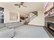 Spacious living room with hardwood floors, a modern fireplace, and large windows provides ample natural light at 9099 Prairie Sky Ln, Lone Tree, CO 80124