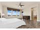 Spacious main bedroom with large windows, plenty of light, en suite bath, and a ceiling fan at 9099 Prairie Sky Ln, Lone Tree, CO 80124