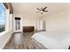 Spacious main bedroom with en suite bath, private balcony, neutral color palette, and a ceiling fan at 9099 Prairie Sky Ln, Lone Tree, CO 80124