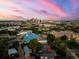 Aerial view of property with Denver city skyline in the background during sunset at 2527 W Dunkeld Pl, Denver, CO 80211