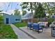 Landscaped backyard with patio area, comfortable seating, and detached garage at 2527 W Dunkeld Pl, Denver, CO 80211