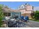 Inviting backyard with patio furniture, grill, and lush green lawn surrounded by a wooden fence at 2527 W Dunkeld Pl, Denver, CO 80211