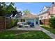 Inviting backyard with patio furniture, grill, and lush green lawn surrounded by a wooden fence at 2527 W Dunkeld Pl, Denver, CO 80211