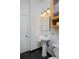 Bathroom featuring a pedestal sink, and a cabinet at 2527 W Dunkeld Pl, Denver, CO 80211