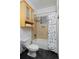 A cozy bathroom area with a shower-tub and storage at 2527 W Dunkeld Pl, Denver, CO 80211