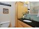 Bathroom showcasing a granite countertop, vessel sink, and a cabinet at 2527 W Dunkeld Pl, Denver, CO 80211