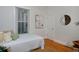 Bright bedroom with a twin bed, stylish rug, and ample natural light from a large window at 2527 W Dunkeld Pl, Denver, CO 80211