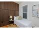 Bright bedroom featuring a textured wall, window, and modern decor at 2527 W Dunkeld Pl, Denver, CO 80211
