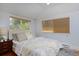 Bright bedroom featuring a cozy bed, windows, and natural light at 2527 W Dunkeld Pl, Denver, CO 80211