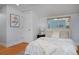 Comfortable bedroom with a plush bed, accent pillows, and natural light at 2527 W Dunkeld Pl, Denver, CO 80211