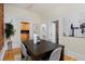 Bright dining area features hardwood floors, access to kitchen and bathroom, and seats four at 2527 W Dunkeld Pl, Denver, CO 80211