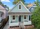 Inviting blue house with a cozy front porch and well-maintained landscaping at 2527 W Dunkeld Pl, Denver, CO 80211