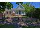 Charming blue home featuring a well-manicured front yard and black iron fence at 2527 W Dunkeld Pl, Denver, CO 80211