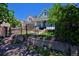 Charming blue home featuring a well-manicured front yard and black iron fence at 2527 W Dunkeld Pl, Denver, CO 80211