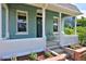 Inviting front porch with seating, complemented by neat landscaping and brick accents at 2527 W Dunkeld Pl, Denver, CO 80211
