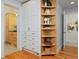 Hallway with custom cabinetry and open shelving at 2527 W Dunkeld Pl, Denver, CO 80211