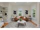 Bright living room featuring a leather sofa, stylish decor, and ample natural light at 2527 W Dunkeld Pl, Denver, CO 80211