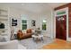 Bright living room with hardwood floors, a brown sofa, and a decorative rug at 2527 W Dunkeld Pl, Denver, CO 80211