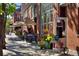 Picturesque street view featuring outdoor seating at a restaurant, flowers, and charming decor at 2527 W Dunkeld Pl, Denver, CO 80211