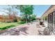 A well-maintained backyard with mature trees and a spacious patio at 4940 E Donald Ave # 8, Denver, CO 80222
