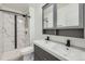 Modern bathroom featuring a new vanity, dual sinks, and tile surround shower at 4940 E Donald Ave # 8, Denver, CO 80222