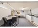 Well-lit community room featuring tables, chairs, washer/dryer, and plenty of storage at 4940 E Donald Ave # 8, Denver, CO 80222
